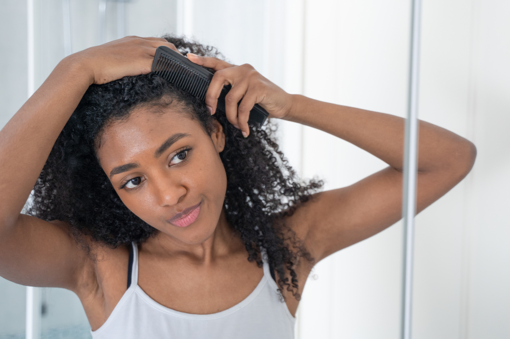 Biracial hair care routine - mixed girl brushing hair