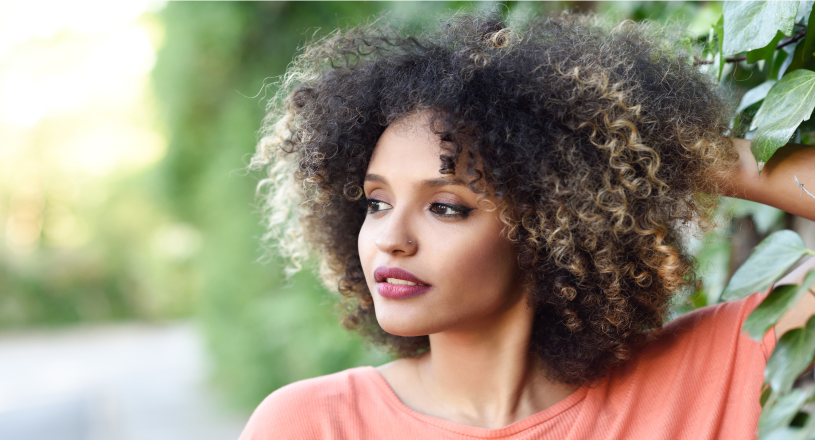 medium-shot-smiley-woman-using-hair-product 1